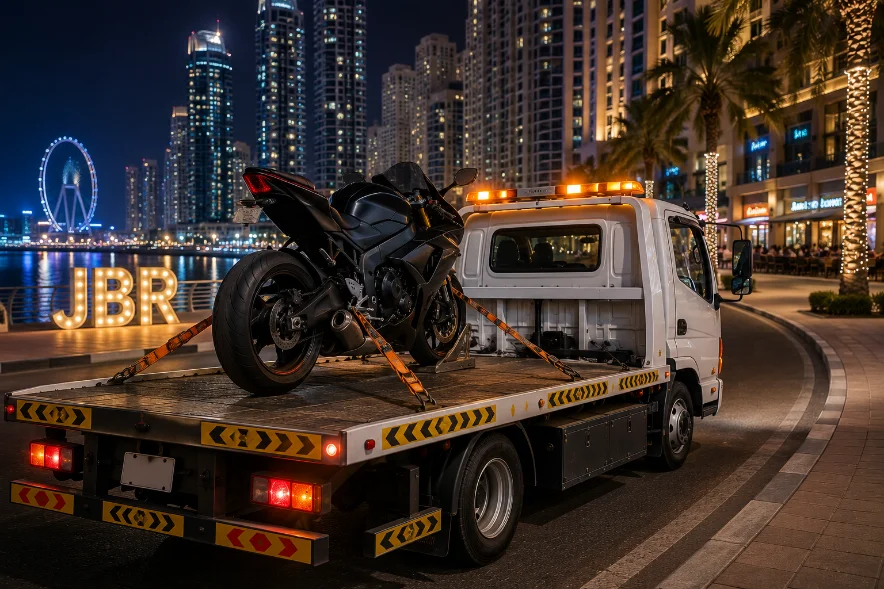 motorcycle strapped to a recovery truck